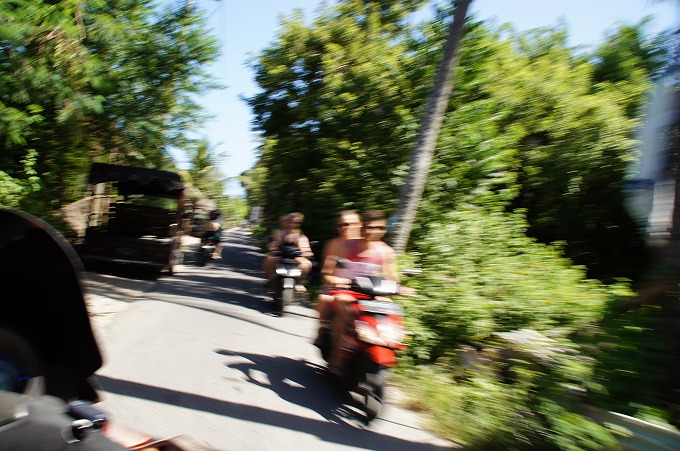 観光客が運転するバイクが沢山行き来するレンボンガン島の道
