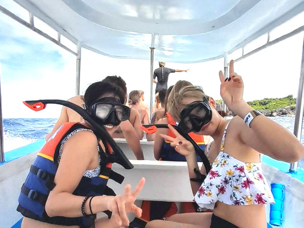 レンボンガン、ペニダ島の絶景シュノーケリングへ出発するボートに乗る各国のお客様とバリ姫の2名の女性モデル