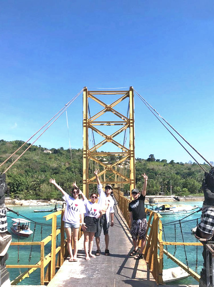 天気の良い日のイエローブリッジで記念撮影をする笑顔のカッコいい男女4組